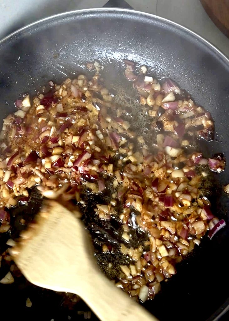 Sauté Garlic & Onion
In the same pan, melt butter and sauté minced garlic and chopped red onion until fragrant.