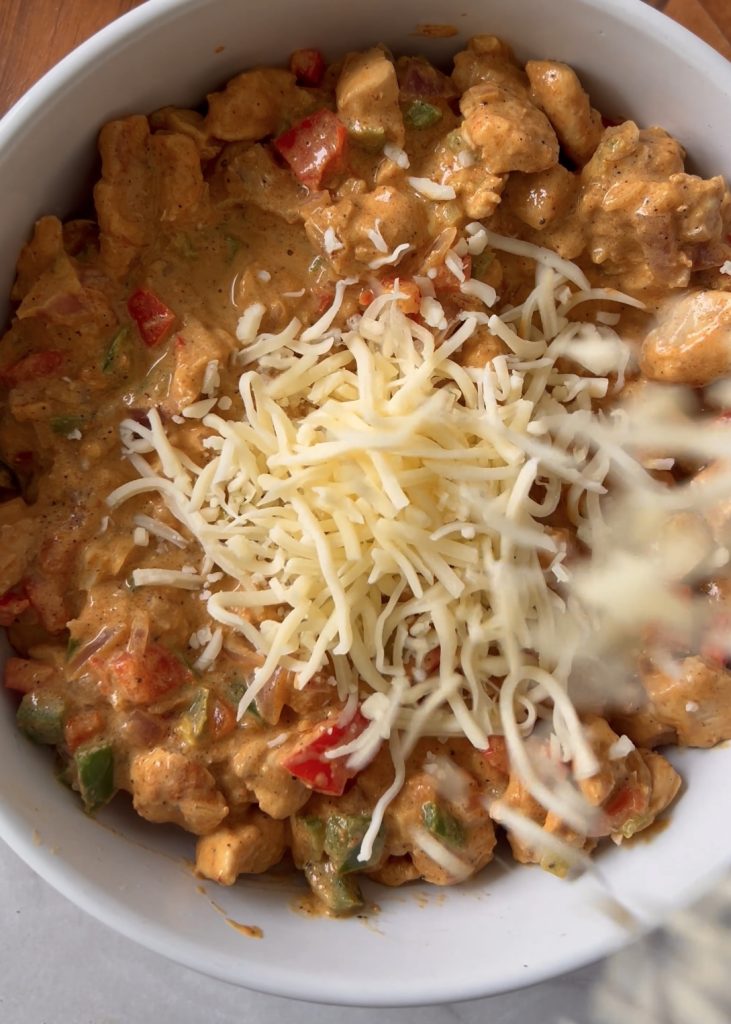 Make the Filling
Stir in cream, cream cheese, and mozzarella until creamy and thickened. Let cool slightly.