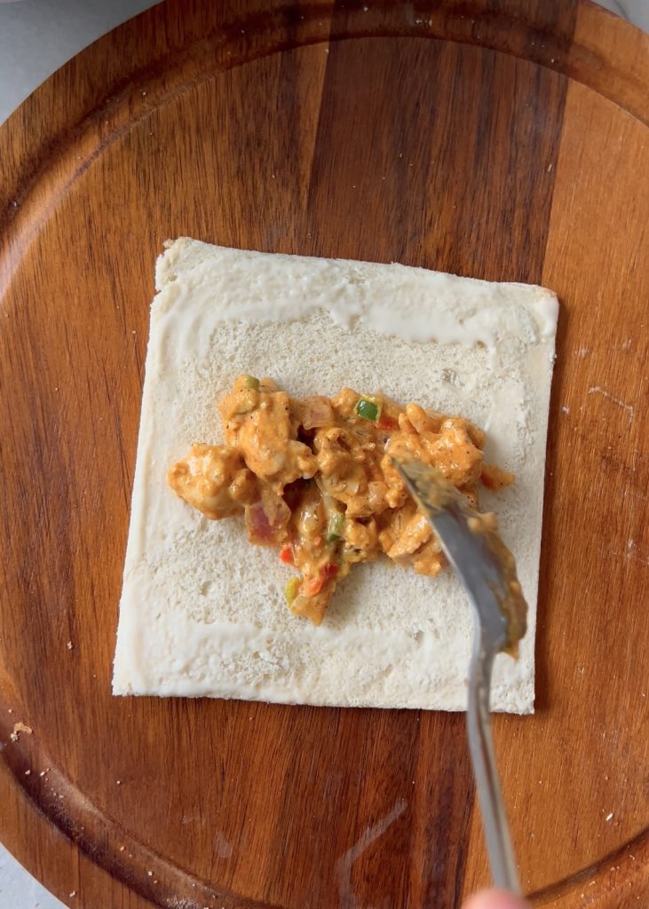  Prepare the Bread
Trim crusts from bread slices and roll them flat with a rolling pin.