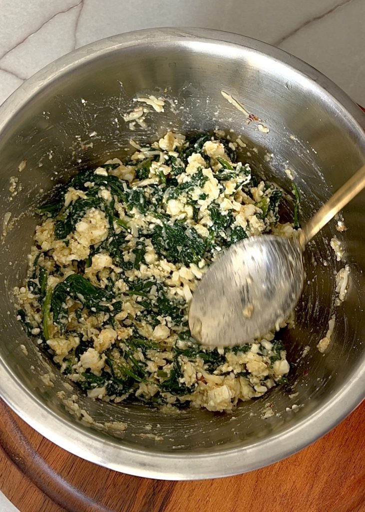 Mix the Filling: Combine spinach, cheeses, egg, and spices in a bowl.
