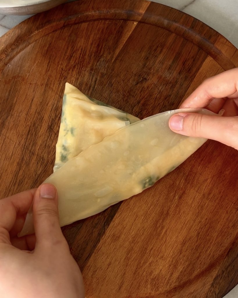Assemble the Pockets: Add filling to the center of each rice paper stack, fold, and place on a tray.