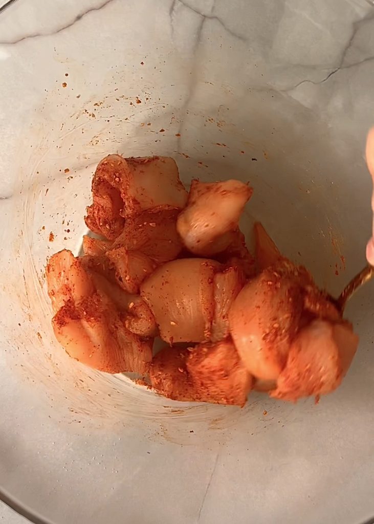 Marinate, coat, and bake: Whisk eggs with sriracha, dip the seasoned chicken in the mixture, coat with crushed cornflakes, and bake until golden and cooked through