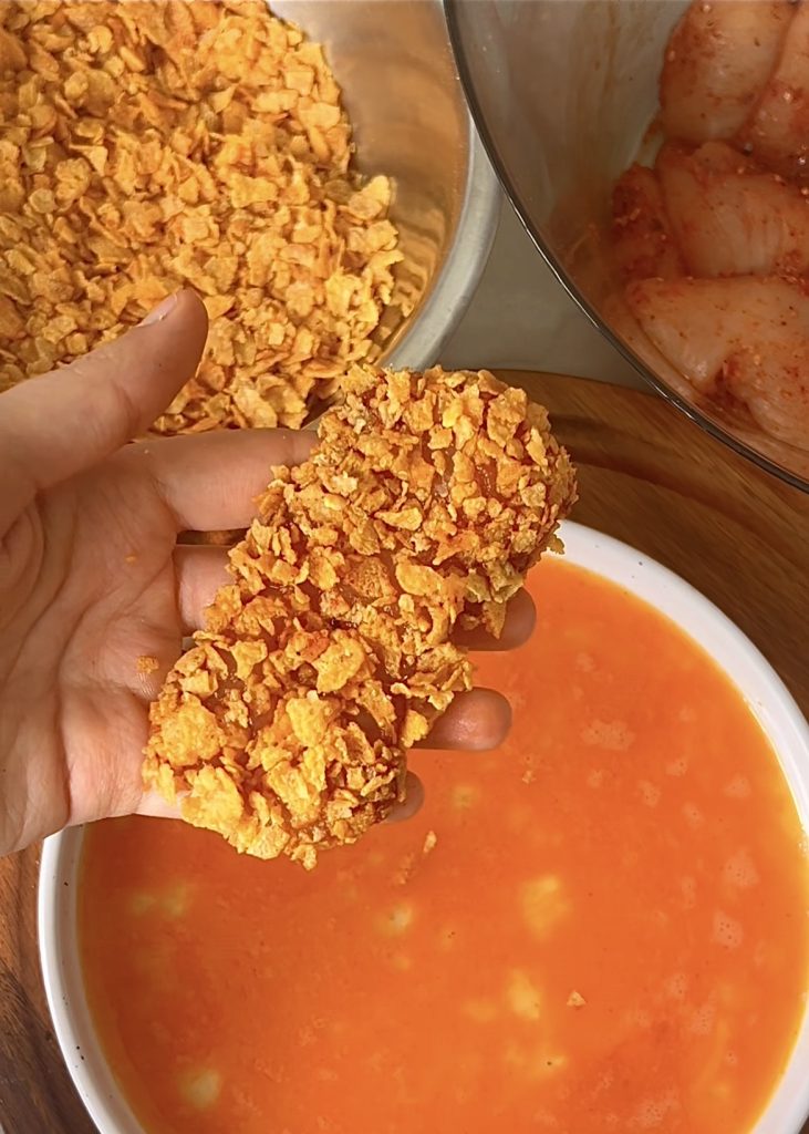 Toss the tenders: Coat the crispy baked chicken in the hot honey garlic sauce.