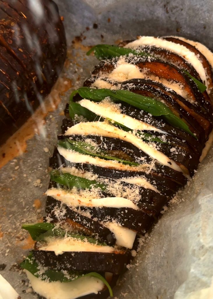 Add Cheese and Basil – Once baked, tuck slices of mozzarella and sprinkles of Parmesan between the slits. Add fresh basil.