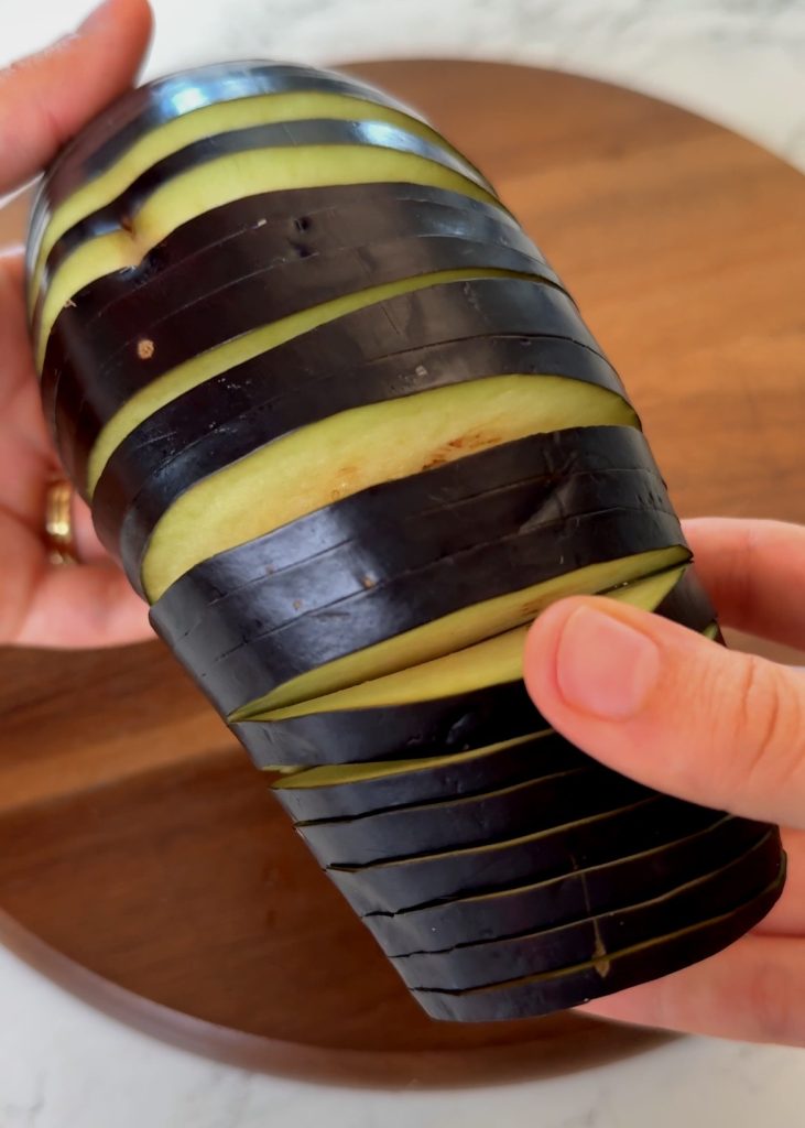 Prepare the Eggplant – Slice the eggplants thinly without cutting all the way through. Mix olive oil with thyme, oregano, and paprika. Brush the mixture into each slit.