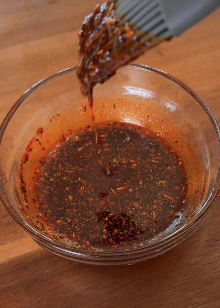 Mix olive oil with thyme, oregano, and paprika. Brush the mixture into each slit.