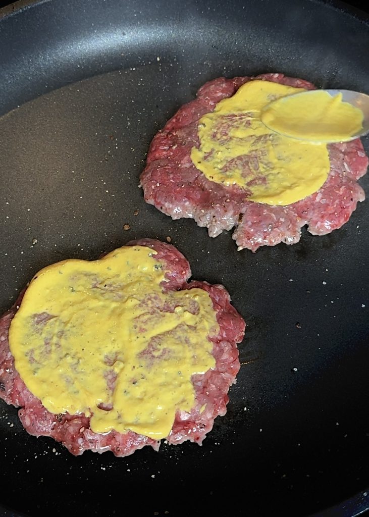 Shape the patties by forming four seasoned ground beef patties.