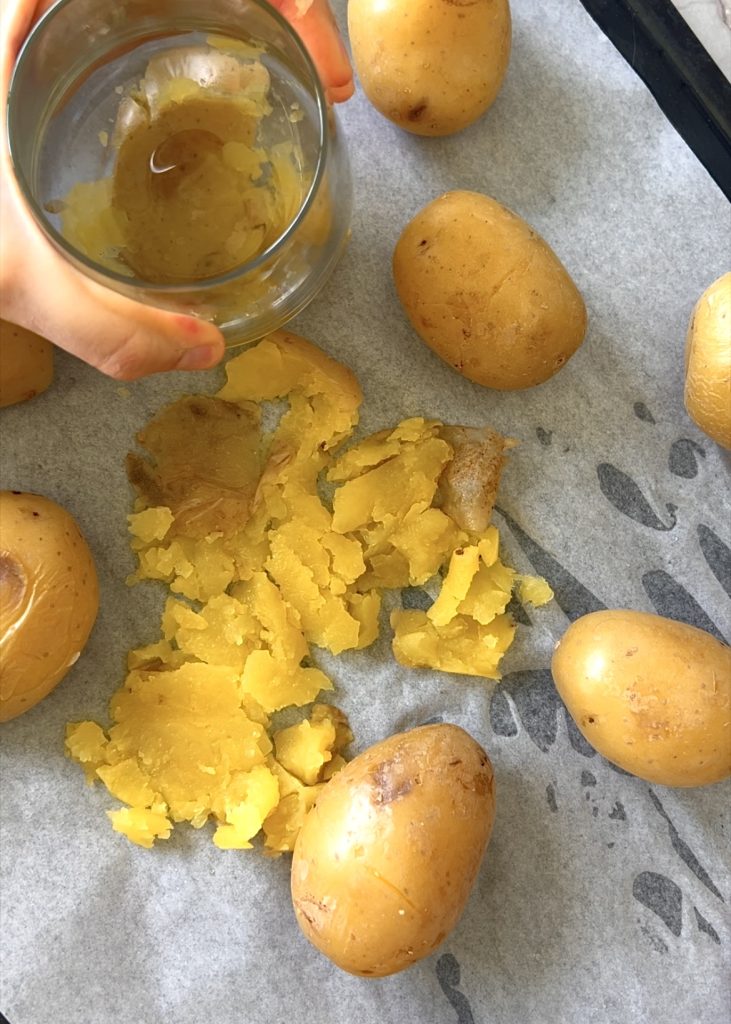Boil the potatoes until tender, let them cool slightly, then smash, season, and roast until crisp.