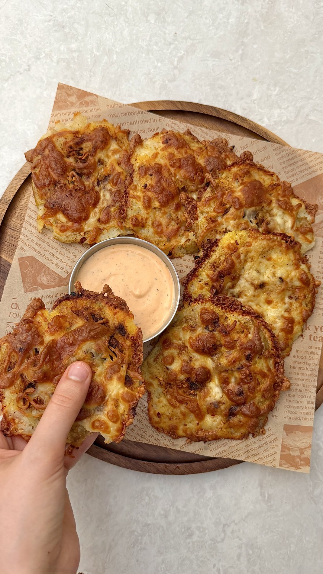 Golden cheesy smashed potatoes with creamy sriracha dip