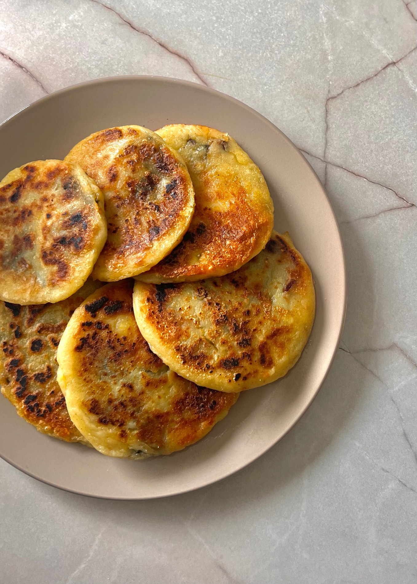 Golden crispy potato pancakes filled with mushrooms, spinach and mozzarella