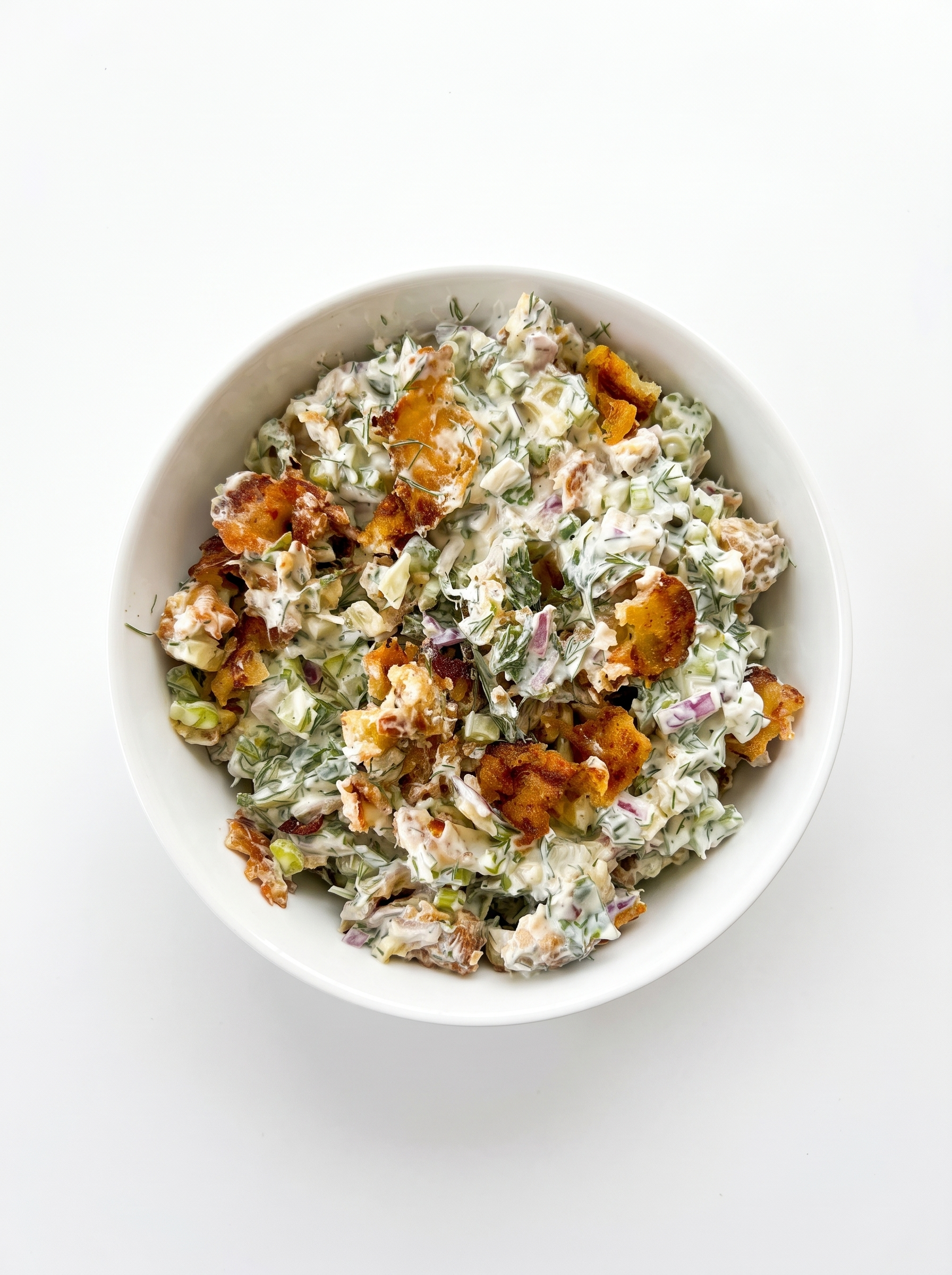 Creamy crispy potato salad on a white plate