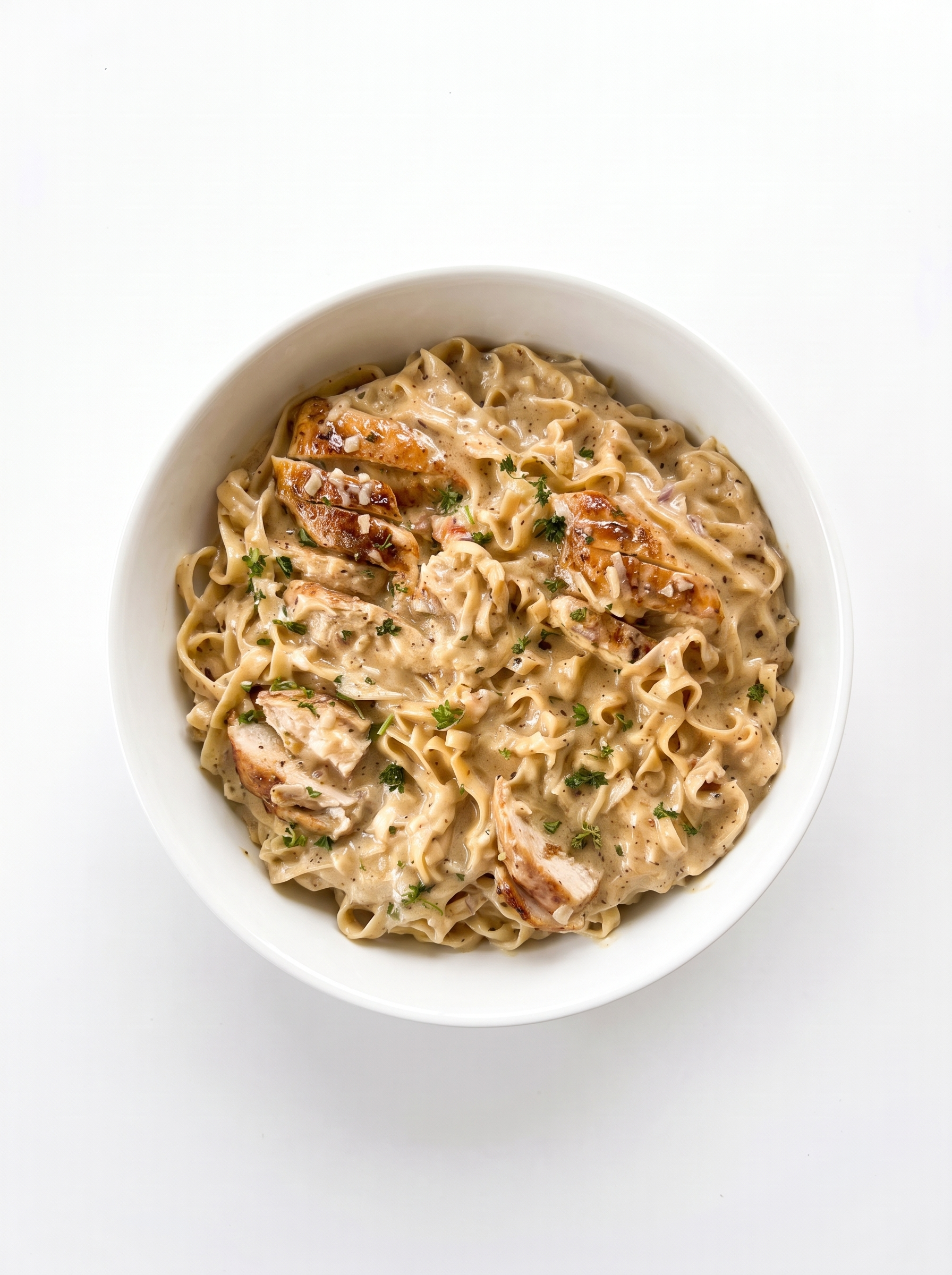 Creamy Parmesan chicken pasta on a white plate