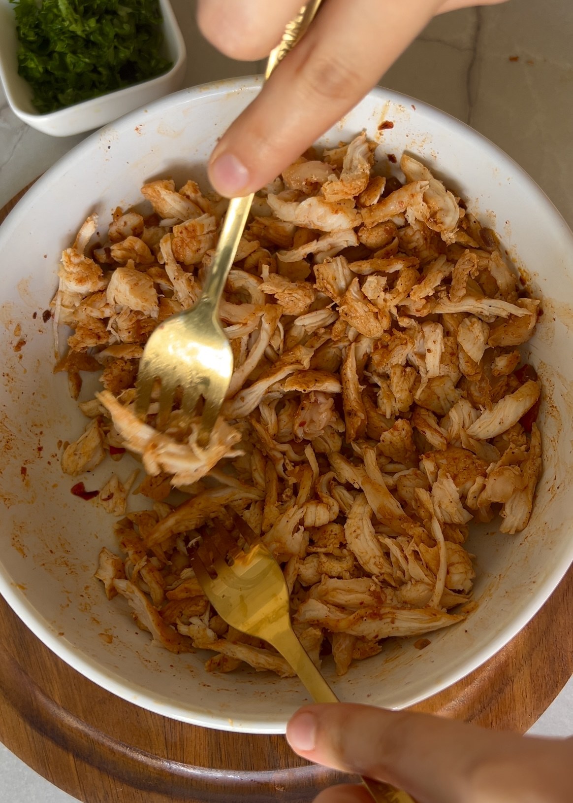 Shredding cooked chicken for the taco filling