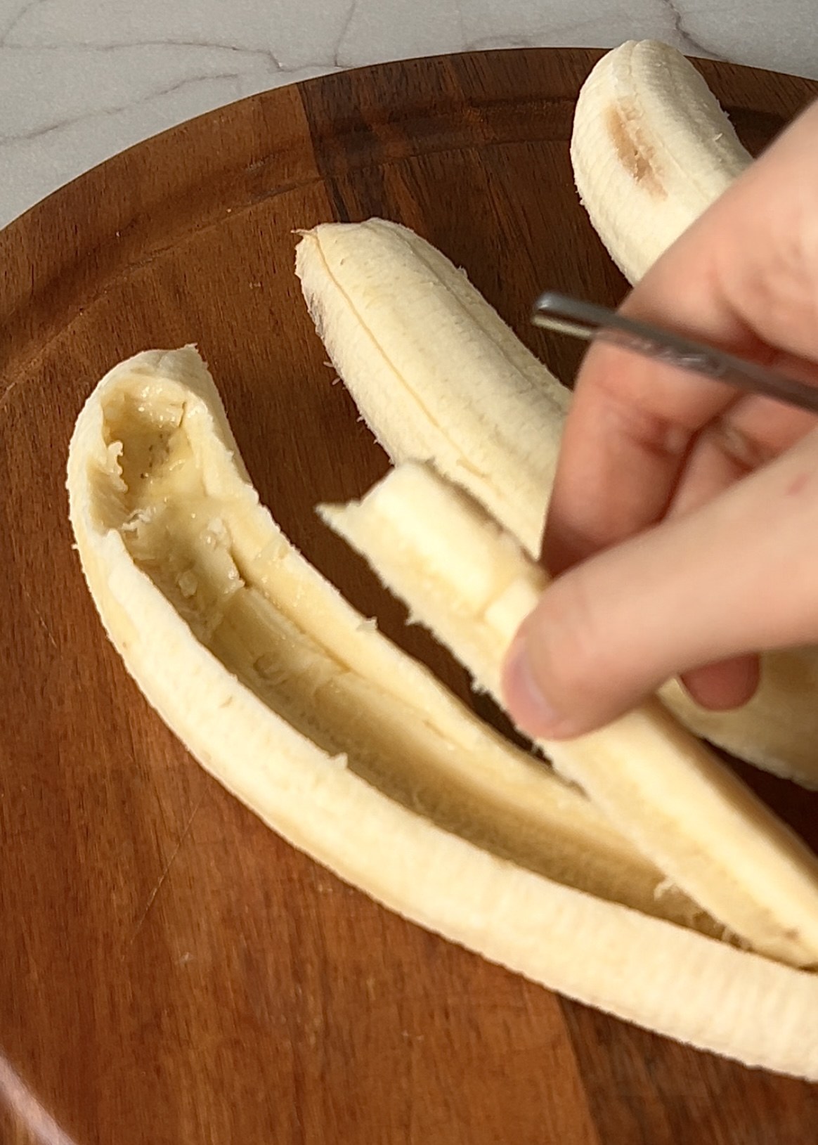 Bananas with a shallow channel scooped out for filling