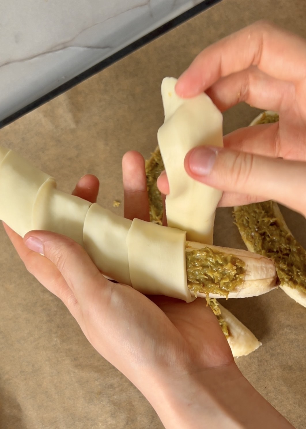 Filled banana wrapped in strips of puff pastry
