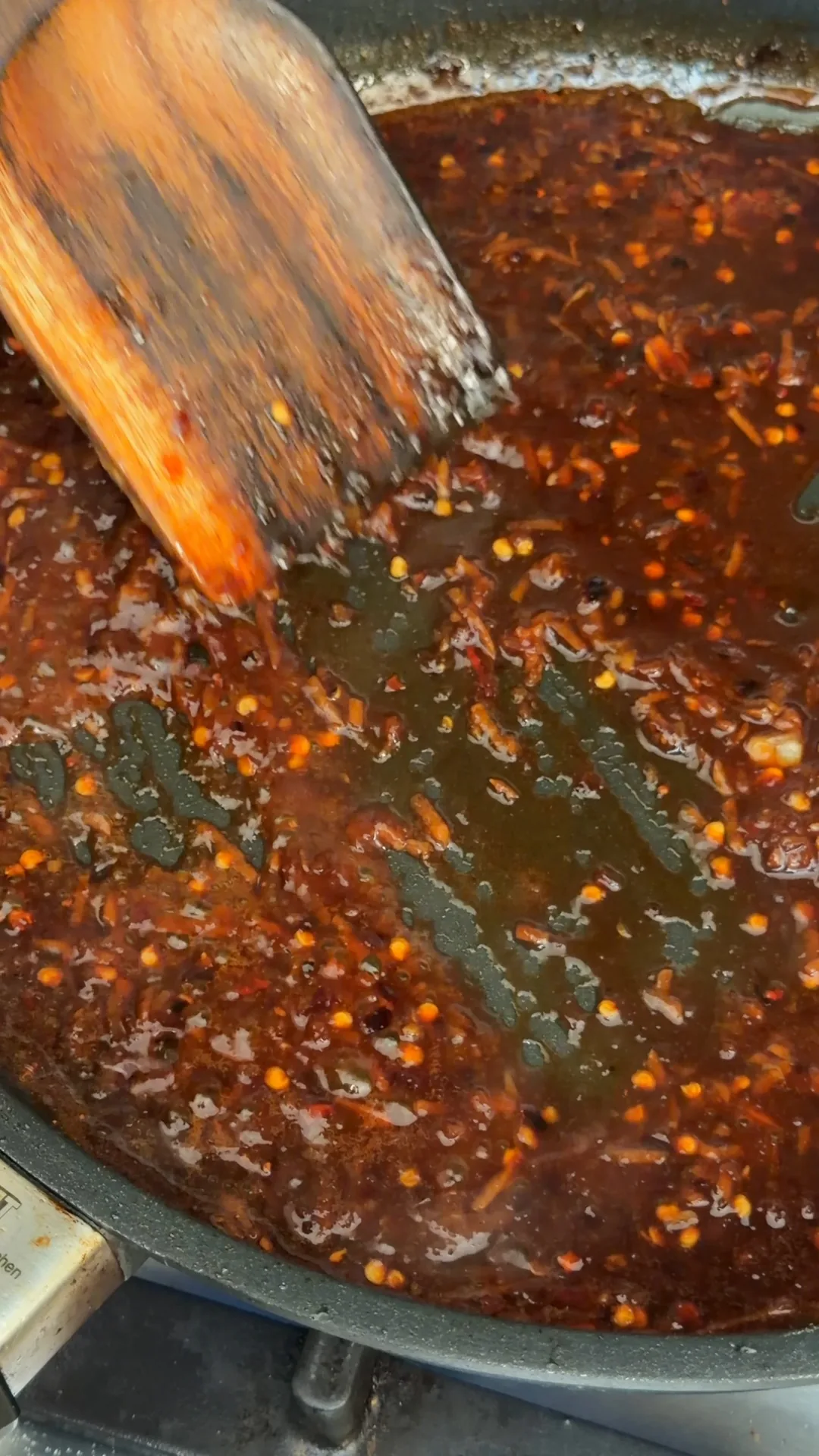 Honey lemon garlic sauce being stirred in a frying pan