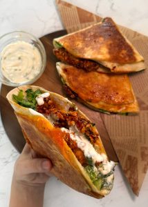 Crispy chicken burger folded wrap with cheddar and lettuce