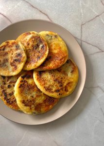 Golden crispy potato pancakes filled with mushrooms, spinach and mozzarella