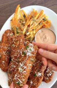 Garlic Parmesan chicken tenders with fries and dipping sauce