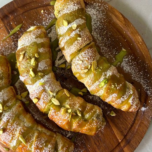 Golden puff pastry bananas with pistachio filling