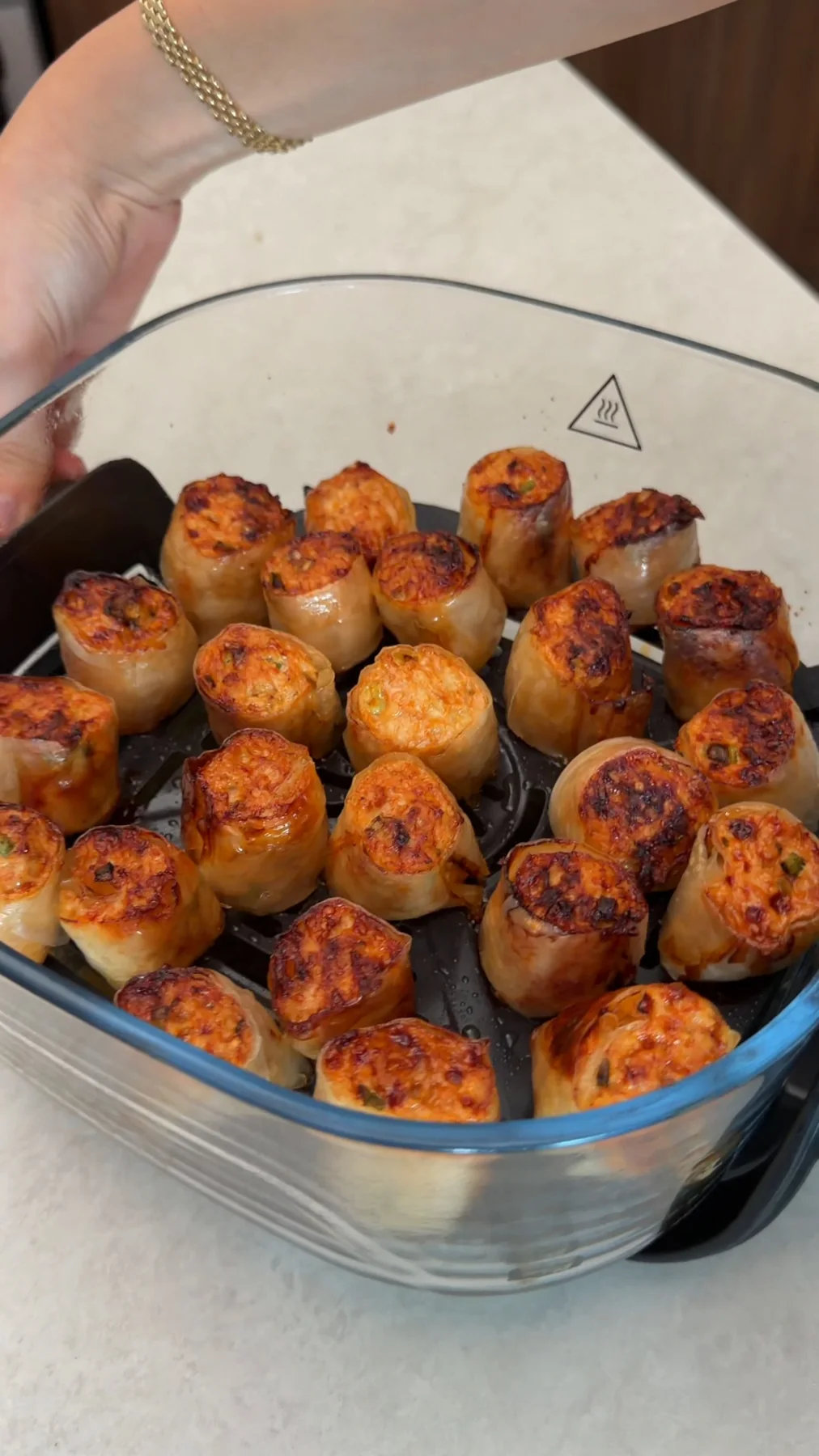 Golden cooked chicken bites in the air fryer basket